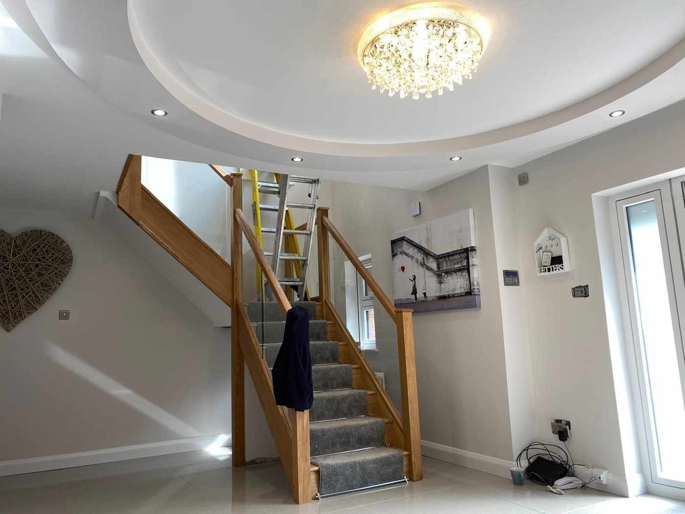 Renovated hallway with feature ceiling and chandelier