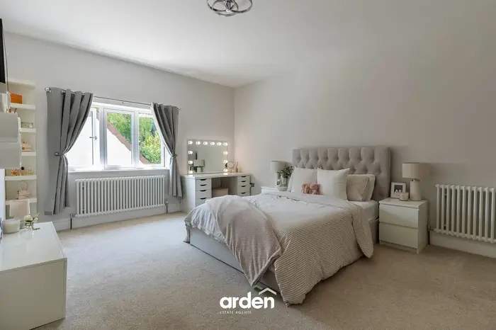 Double bedroom in cream with a vanity area