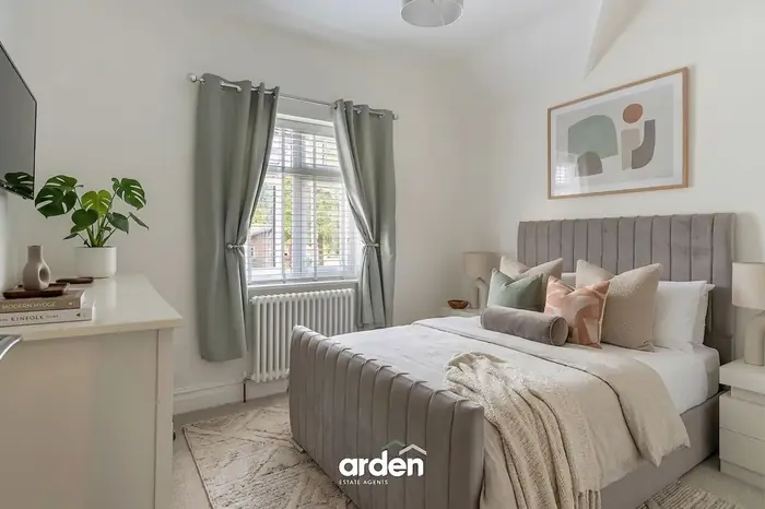 Guest bedroom with a velvet bed and full height window