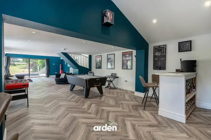 Games room with a pool table and fitted bar