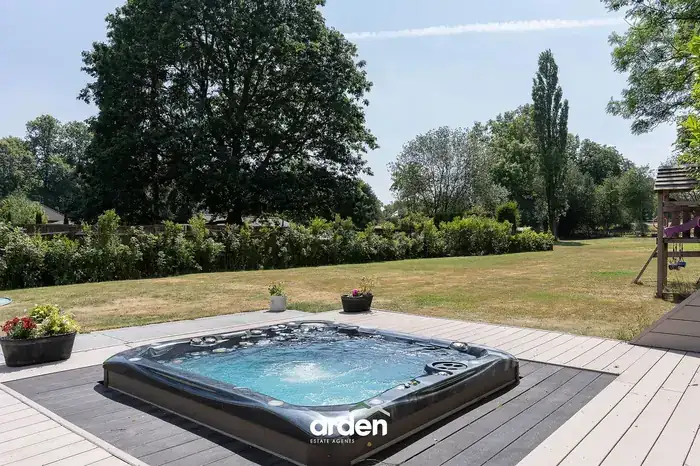 Decked hot tub area looking down the garden
