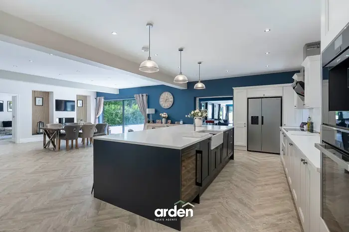 Shaker kitchen with quartz island and dining area beyond