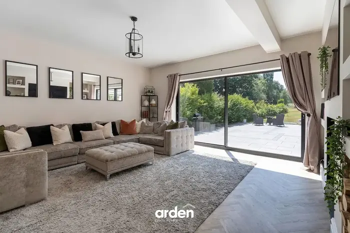 Living room with a corner sofa and sliding doors onto the terrace